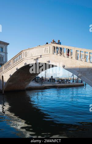 Chioggia bridge, view of the Ponte di Vigo - a historic 14th century bridge designed in the Venetian style spanning the Canal Vena in Chioggia, Italy Stock Photo