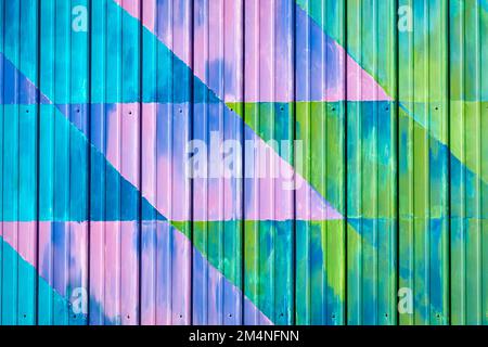 Colorful Amish star quilt patterns painted on aluminum siding in cool color tones. Stock Photo