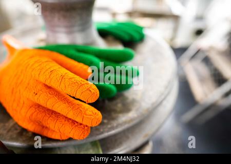 fisherman wearing waterproof clothes and gloves on a fishing boat in australia on a boat Stock Photo
