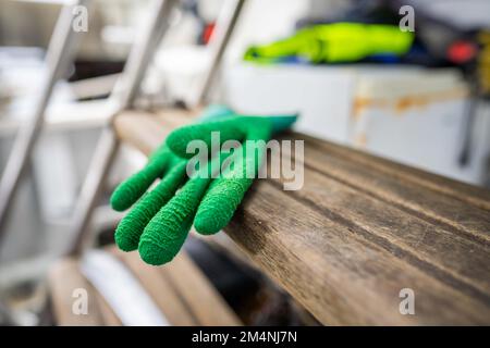 fisherman wearing waterproof clothes and gloves on a fishing boat in australia on a boat Stock Photo