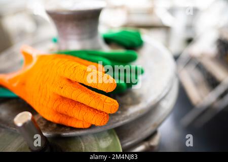 fisherman wearing waterproof clothes and gloves on a fishing boat in australia on a boat Stock Photo