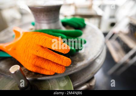 fisherman wearing waterproof clothes and gloves on a fishing boat in australia on a boat Stock Photo