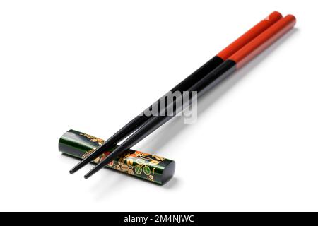 Pair of Japanese chopsticks on a chopstick rest isolated on white background Stock Photo