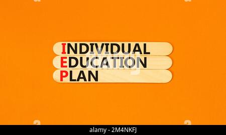 IEP individual education plan symbol. Concept words IEP individual education plan on wooden sticks on beautiful orange background. Business IEP indivi Stock Photo