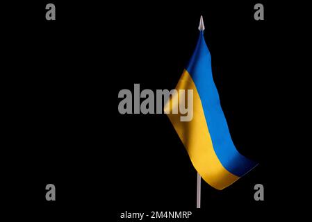 Flag of Ukraine on dark background. Yellow and blue, the colors of the national, fabric ribbon on a black background. Symbol of the independence of Stock Photo