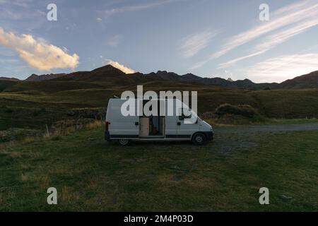 Camper Van in the Pyrenees Mountains at the french and spanish border during sunset, Frontera del Portalet, Huesca, Spain Stock Photo