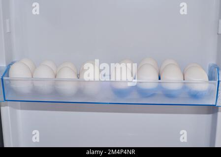 White eggs in rows in refrigerator boxes Stock Photo