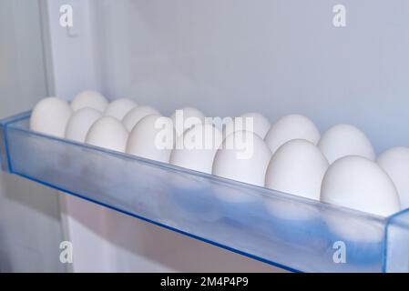 White eggs in rows in refrigerator boxes Stock Photo