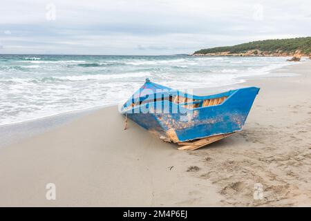 Old fishing boat stranded on beach, Bini Gaus, Menorca, Balearic islands, Spain. Stock Photo