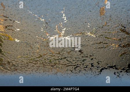 Frozen car windscreen close up view from the inside looking out defrosting under car heaters. Stock Photo