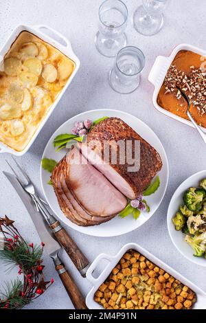 Christmas dinner with honey spiral sliced ham and side dishes Stock Photo