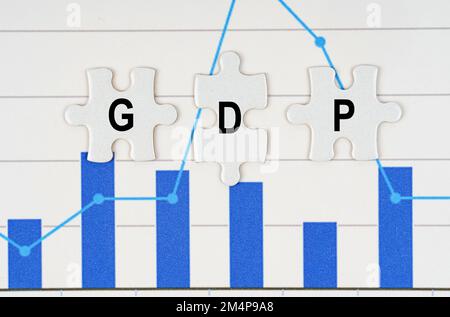 Business concept. On business reports - diagrams are puzzles with the inscription - GDP Stock Photo