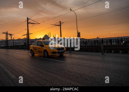 istanbul,Turkey - 20 December 2019 : Photo of yellow taxi on the streets of historic istanbul at magnificent sunset Stock Photo