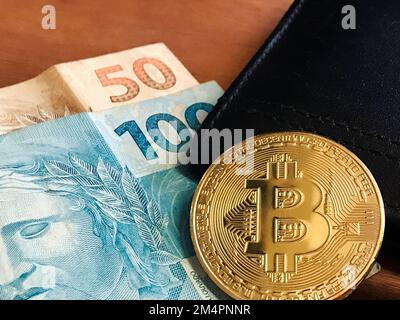 Bitcoin With Real Brazilian Money on Letter Wallet on Wooden Table. Space for text. Stock Photo