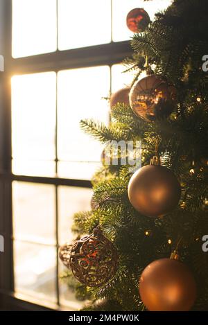 Close the balls on the Christmas tree. Bokeh garlands in the background. New Year's concept. Stock Photo