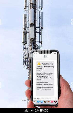 Symbolic image Cell broadcast, warning service via mobile phone, by SMS, to all devices located in the area of radio cells, transmission masts, which Stock Photo