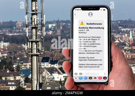 Symbolic image Cell broadcast, warning service via mobile phone, by SMS, to all devices located in the area of radio cells, transmission masts, which Stock Photo