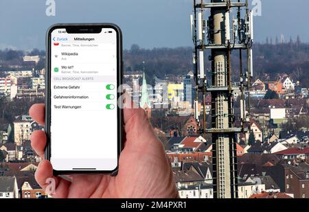 Symbolic image Cell broadcast, warning service via mobile phone, by SMS, to all devices located in the area of radio cells, transmission masts, which Stock Photo