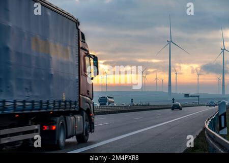 A44 motorway, near Jüchen, crossing the Garzweiler open-cast lignite mining area, wind farm along the motorway, sunrise, NRW, Germany Stock Photo