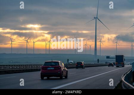 A44 motorway, near Jüchen, crossing the Garzweiler open-cast lignite mining area, wind farm along the motorway, sunrise, NRW, Germany Stock Photo