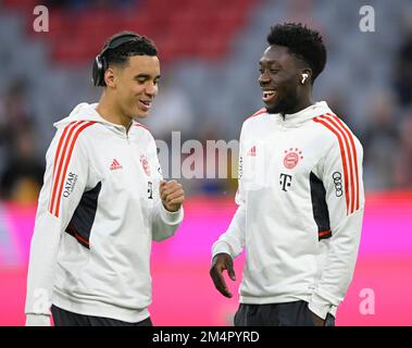 Jamal Musiala FC Bayern Munich FCB (42) in conversation Discussion with Alphonso Davies Bayern FC Munich FCB (19) Headphones, Allianz Arena, Munich Stock Photo