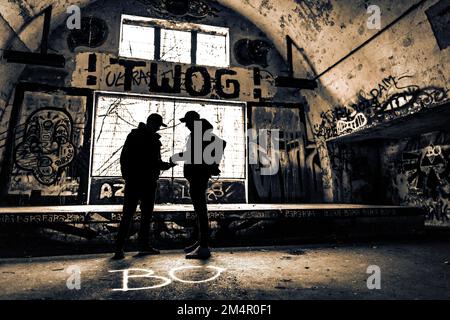 Two men as silhouette in bunker with graffiti walls, black and white, Kaufbeuren, Ostallgaeu, Bavaria, Germany Stock Photo