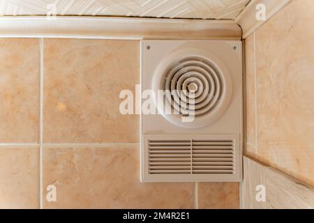 ventilation grate and exhaust fan in the toilet. Air exchange  Stock Photo