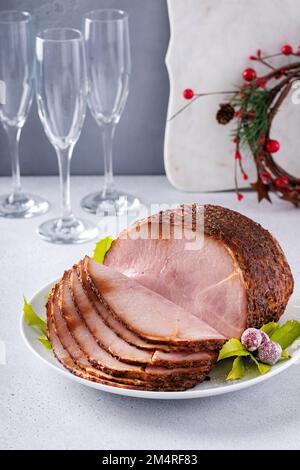 Christmas ham for celebration dinner, spiral sliced ham on a serving plate Stock Photo