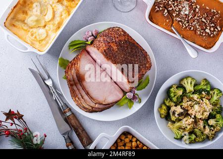 Christmas dinner with honey spiral sliced ham and side dishes Stock Photo