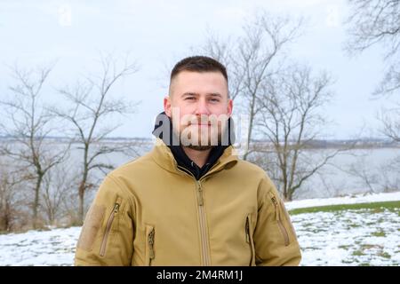 Winter portrait of a handsome man in warm jacket outdoors Stock Photo