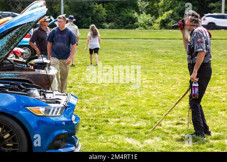 A blue late model Ford Mustang in line with cars being photographed at a car show in Fort Wayne, Indiana, USA. Stock Photo