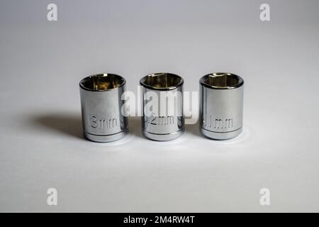 Wrenches with sizes 11mm, 12mm and 13mm. Wrenches of various sizes on white background and isolated focus. Wrench socket. Drive socket Stock Photo