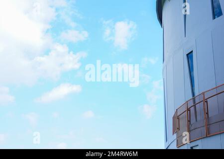 The concept of a building with a unique triangular window with a bright sky background. Building with copy space composition Stock Photo