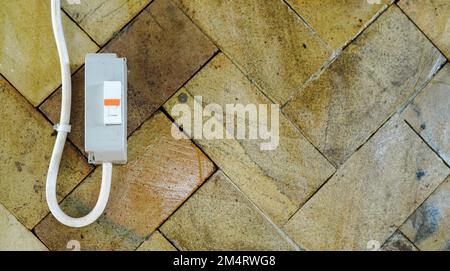 Electric fuse for household with natural stone wall background. Electric fuse with negative space concept. A fuse with an empty space composition Stock Photo