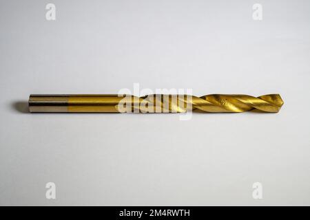 Iron drill bit made of brass with isolated focus concept on white background. Close up of drill bits Stock Photo