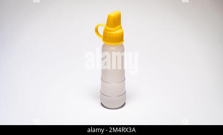 Clear paper glue with a yellow cover isolated on a white background. Item model photo. Bright photo Stock Photo