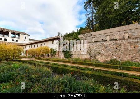 Granada, Spain - Nov 29, 2021: View of The Generalife courtyard, with its famous fountain and garden through an arch. Alhambra de Granada complex at G Stock Photo