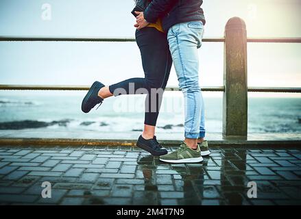 Swept up in love. a young couple embracing on a romantic day outdoors. Stock Photo