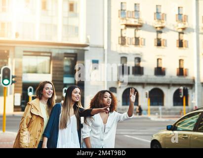 We go wherever the fun is. three friends having fun in the city. Stock Photo