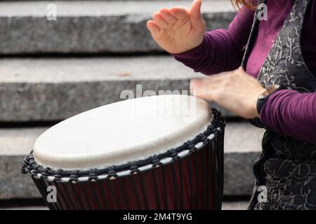playing the drum with hands close-up, musical instrument Stock Photo