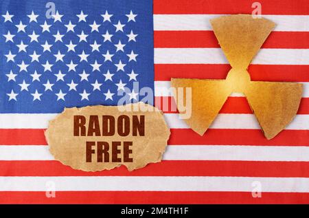 Industry and radiation concept. On the flag of the United States, there is a symbol of radioactivity and a torn cardboard with the inscription - RADON Stock Photo