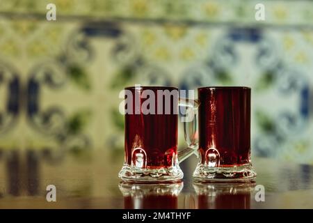 Ginjinha or Ginja - Portuguese liqueur made by infusing ginja berries sour cherry, Prunus cerasus austera, Morello cherry in alcohol aguardente and ad Stock Photo