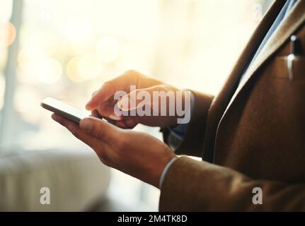 Going wireless. High angle shot of an unrecognizable businessman using a mobile phone. Stock Photo