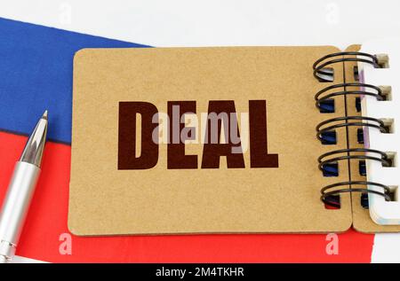 Business and technology concept. On the flag of Russia lies a pen and a notepad with the inscription - Stock Photo