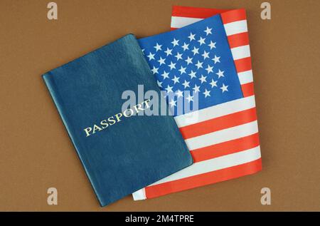 Migration concept. On a brown surface lies a passport with the US flag inside. Stock Photo