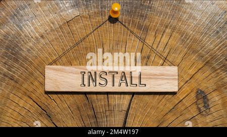 Install word. Background log written on wooden board. Stock Photo