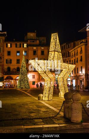 Christmas in Lucca. A giant Christmas star and tree in the beautiful St Michael Square Stock Photo