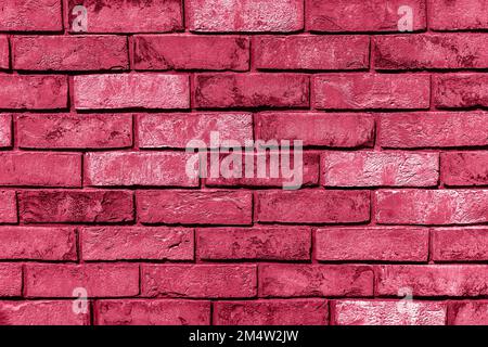 Sunlit weathered brick wall toned in trendy magenta color of year 2023. Brick texture for your design. Copy space. Wallpaper design. Stock Photo