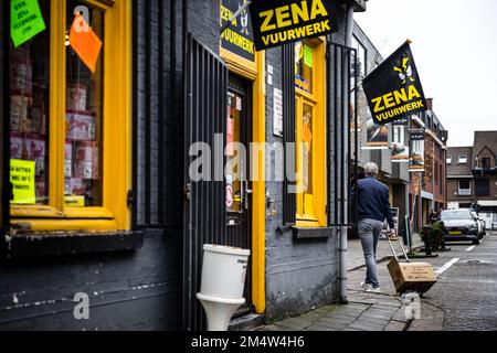 BAARLE-NASSAU - People with boxes of fireworks in the streets of the Dutch-Belgian enclave of Baarle-Nassau. Local residents complain about nuisance caused by large-scale fireworks sales. The village in the Belgian border region attracts many fireworks enthusiasts every year. ANP ROB ENGELAAR netherlands out - belgium out Stock Photo