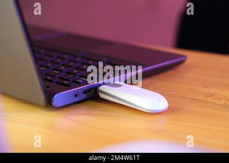 laptop with connected gsm modem on table and pink background Stock ...